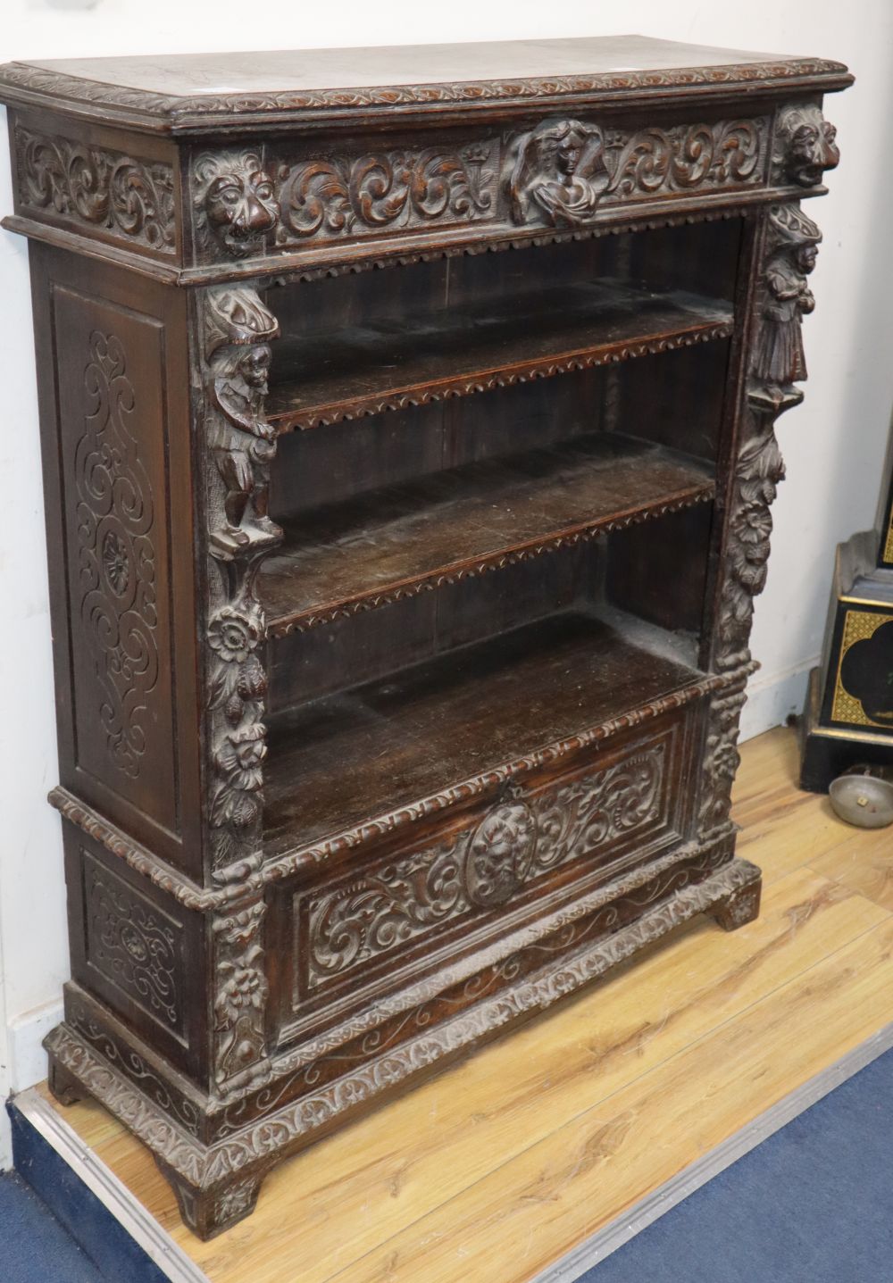A late Victorian Flemish carved oak open bookcase, W.93cm, D.31cm, H.115cm